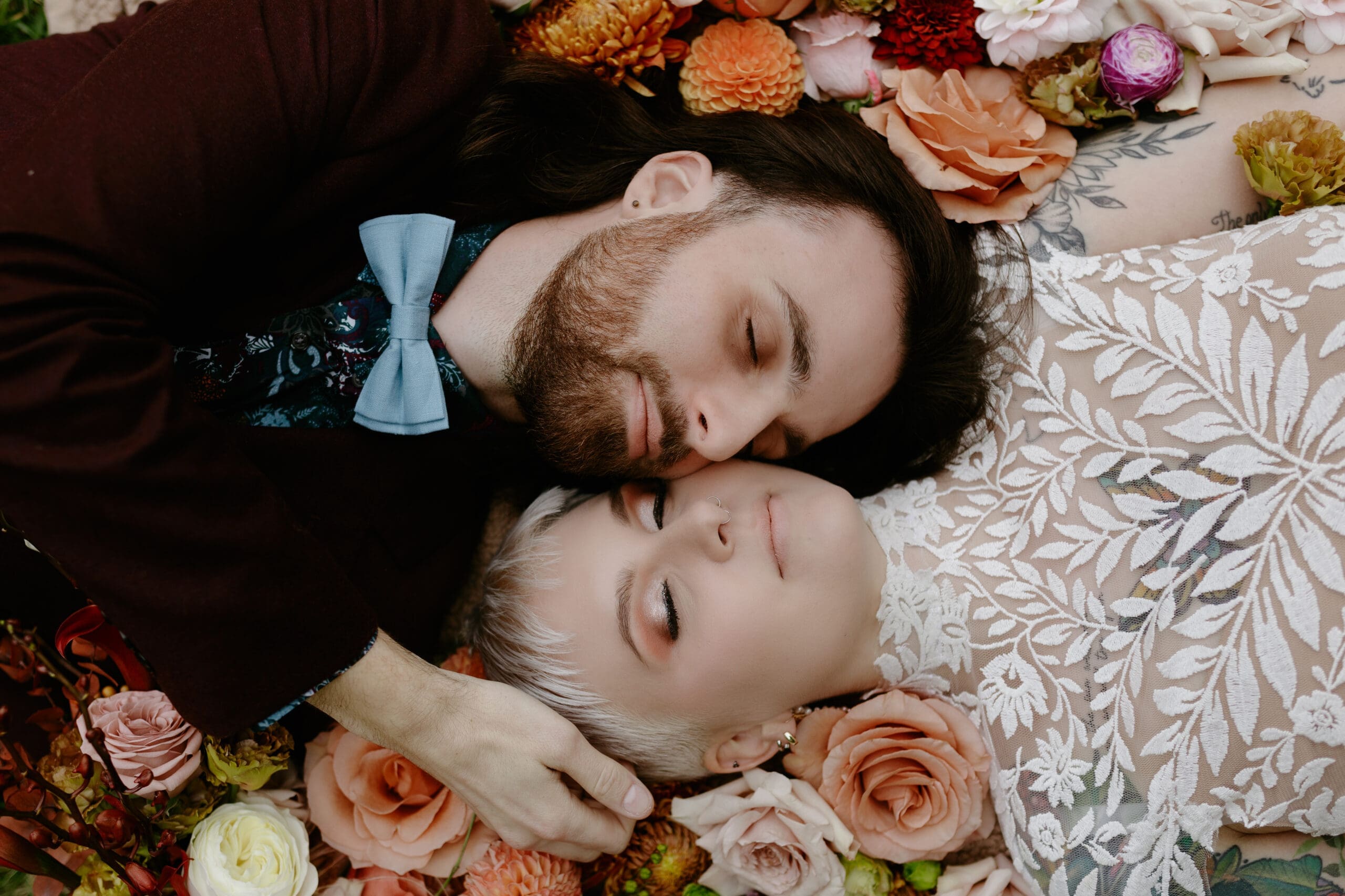 Editorial wedding portrait by Illinois wedding photographer Nicole Kilday Photography featuring a couple surrounded by floral arrangements, demonstrating the artistic wedding photography style and experience included in professional wedding photography pricing.